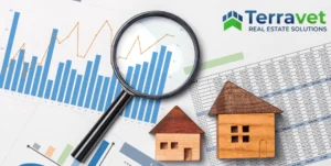 Magnifying glass over graph with model houses representing CAP rates