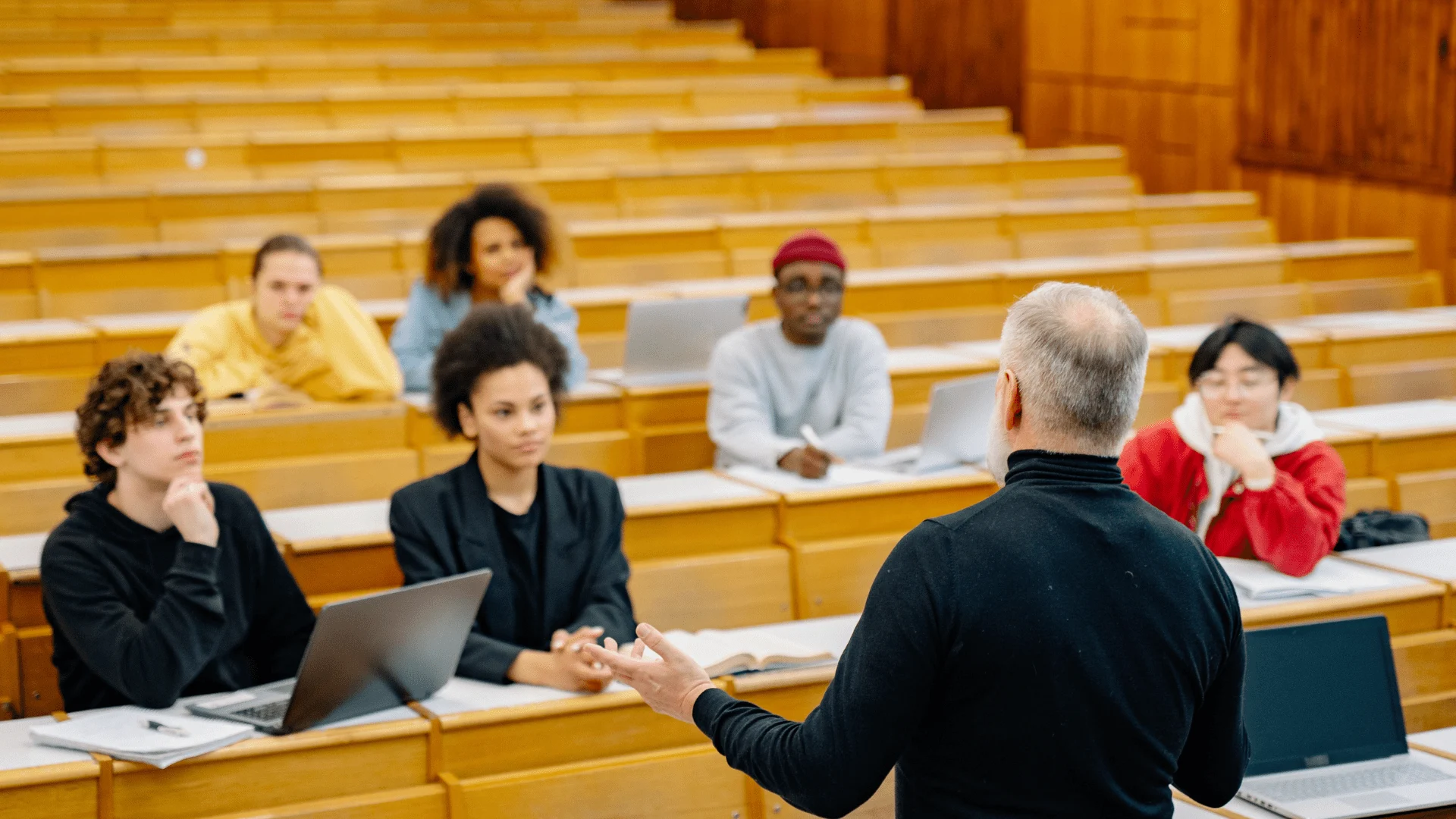 Lecturer speaking to group of young people