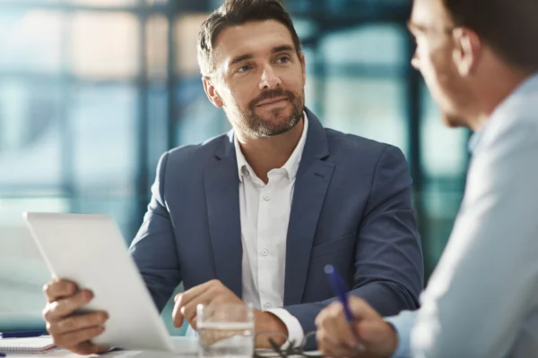 Investor having meeting holding tablet