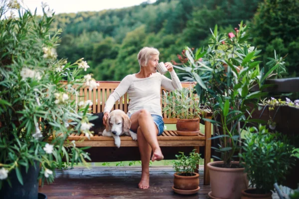 Woman retired from healthcare enjoys hot drink, with their dog